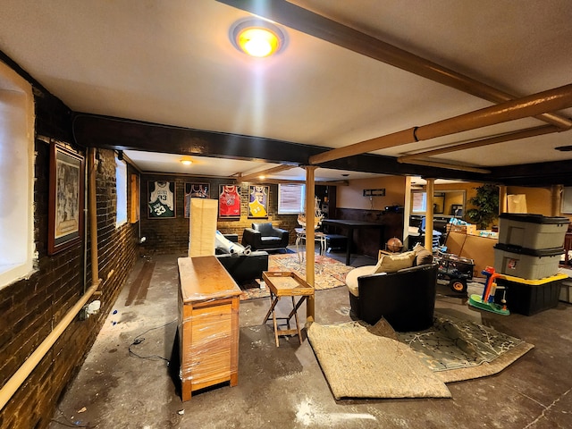 living room with beamed ceiling and brick wall