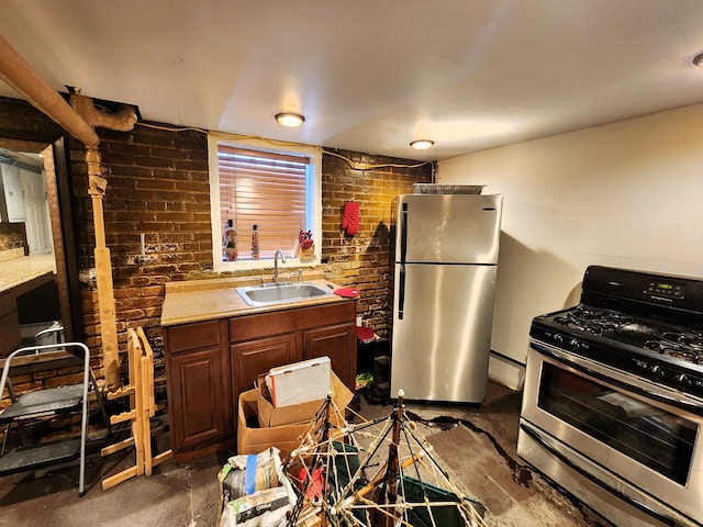 kitchen featuring sink, stainless steel appliances, and brick wall