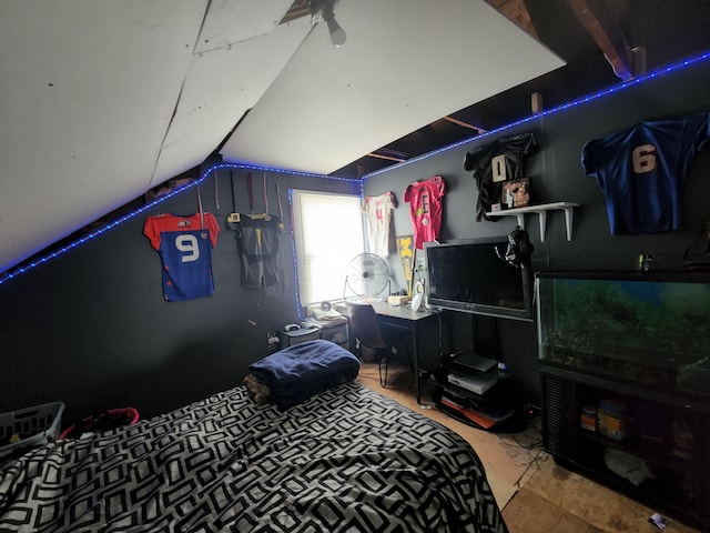 bedroom with concrete flooring and lofted ceiling