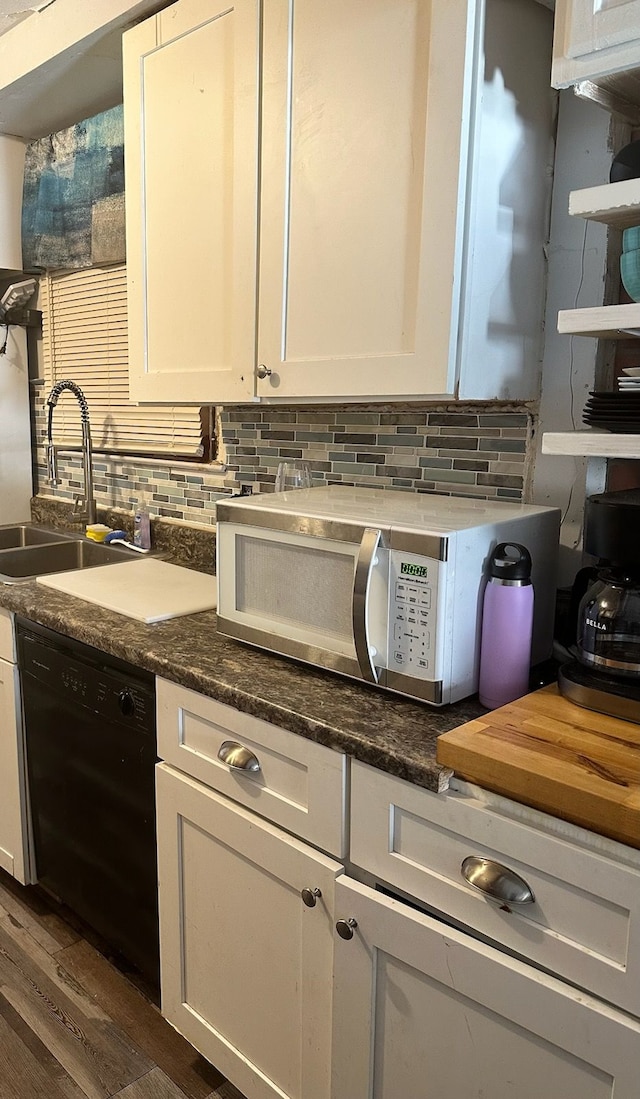 kitchen with white cabinetry, dishwasher, dark wood-type flooring, and sink