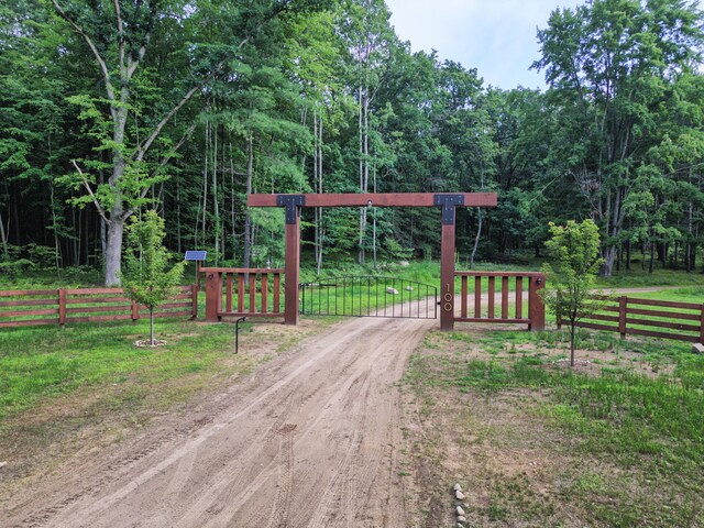 100 W Adams Rd, Farwell, MI 48622 - view of dirt / gravel driveway featuring a gate and a gated entry
