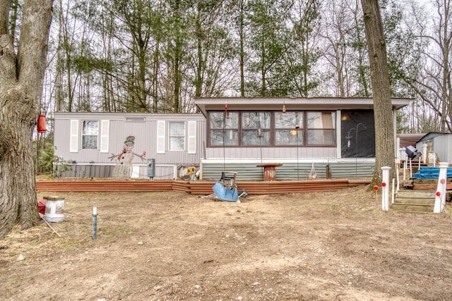 view of front facade with a deck and a sunroom