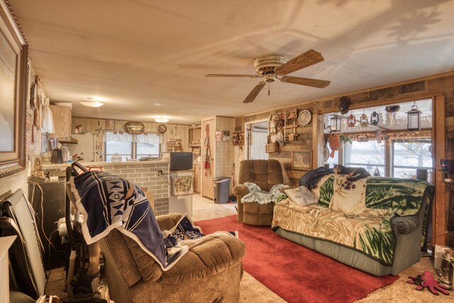 17370 Summit St, Barryton, MI 49305 - carpeted living room with wood walls, plenty of natural light, and a ceiling fan