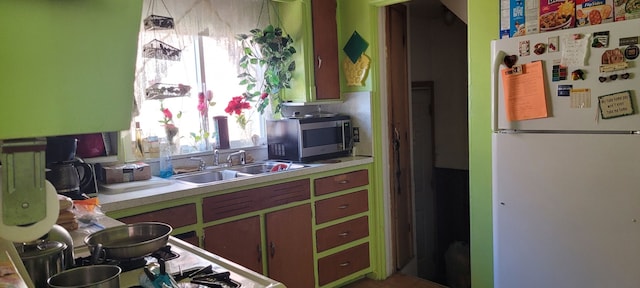 kitchen featuring white fridge and sink