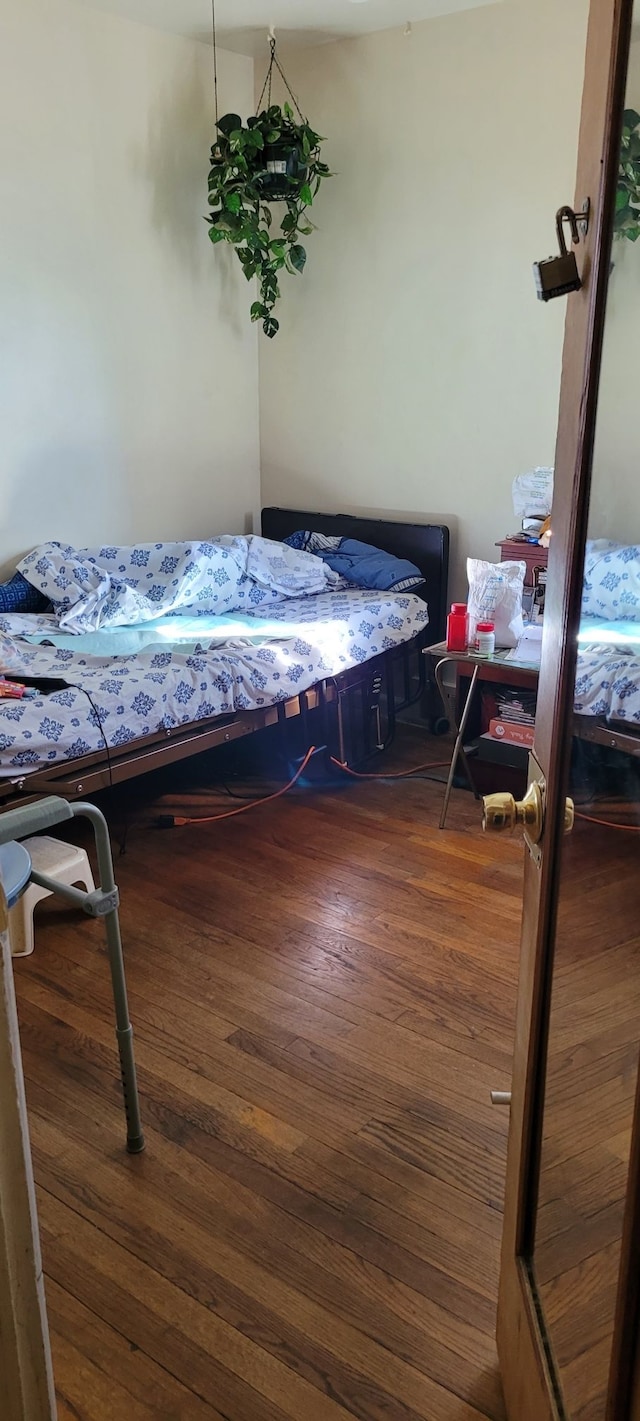 bedroom with dark wood-type flooring