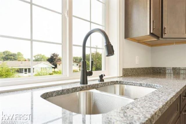 room details with light stone countertops and sink