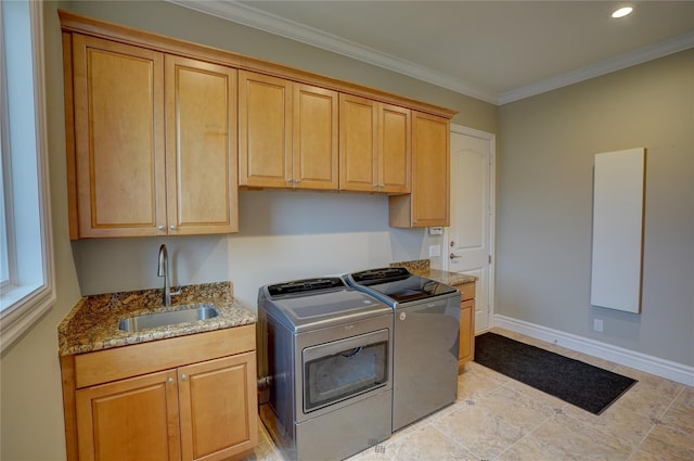 washroom featuring cabinets, washing machine and clothes dryer, ornamental molding, and sink