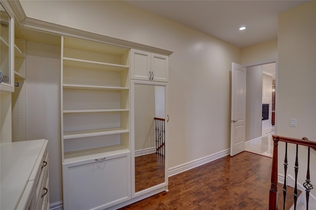 hallway with dark hardwood / wood-style floors