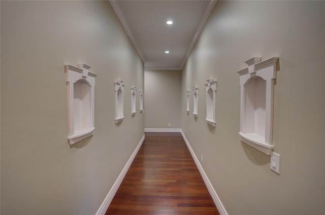 hallway with ornamental molding and dark hardwood / wood-style floors