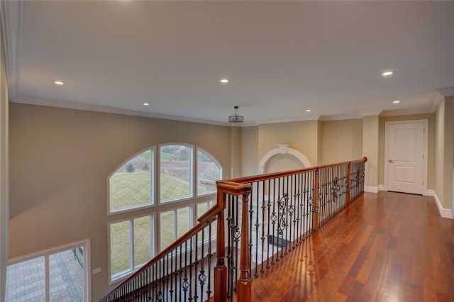 hallway with hardwood / wood-style flooring and crown molding