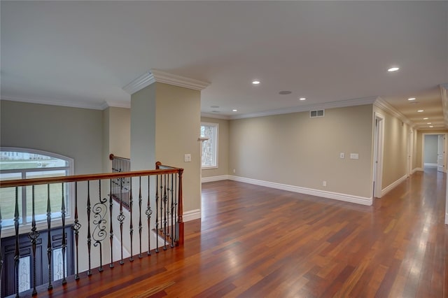 unfurnished room featuring ornamental molding, dark hardwood / wood-style floors, and a healthy amount of sunlight