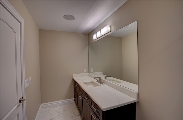 8498 Highgrove Ct, Grand Blanc, MI 48439 - bathroom featuring marble look tile flooring, vanity, and baseboards