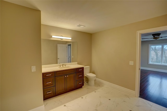 bathroom with ceiling fan, vanity, and toilet