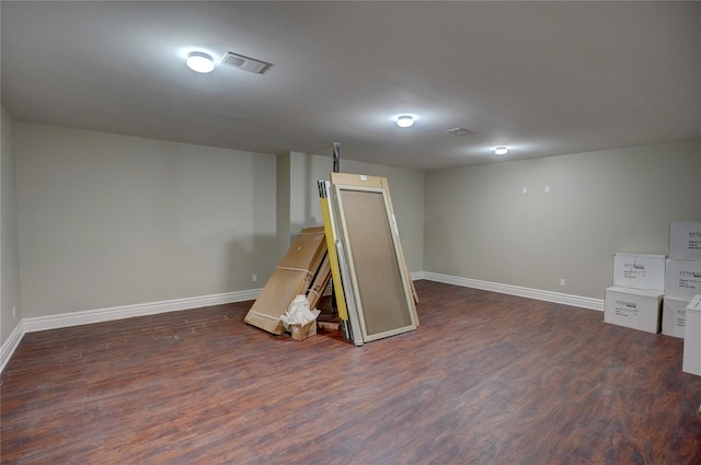 basement featuring dark hardwood / wood-style flooring