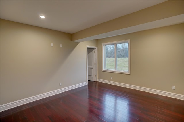 spare room featuring dark hardwood / wood-style flooring