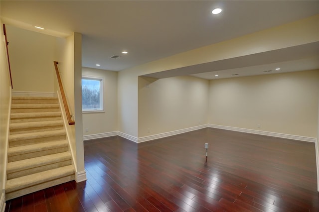 basement with dark hardwood / wood-style flooring