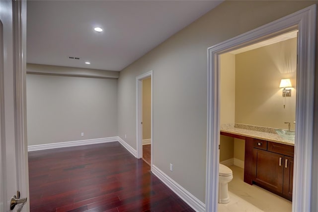 hallway with hardwood / wood-style floors