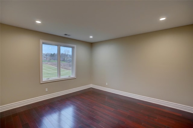 unfurnished room with dark hardwood / wood-style flooring