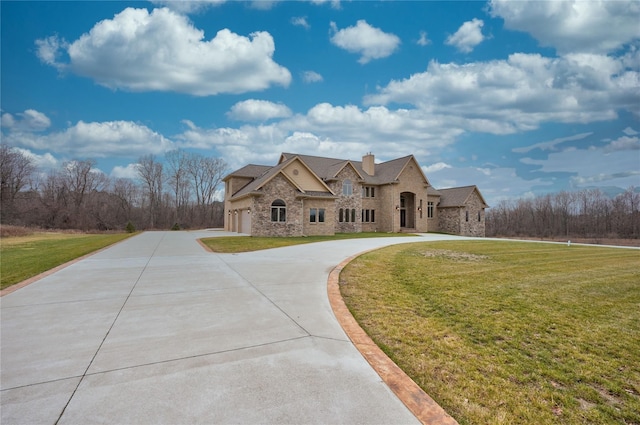 8498 Highgrove Ct, Grand Blanc, MI 48439 - french provincial home with stone siding, curved driveway, a chimney, and a front yard