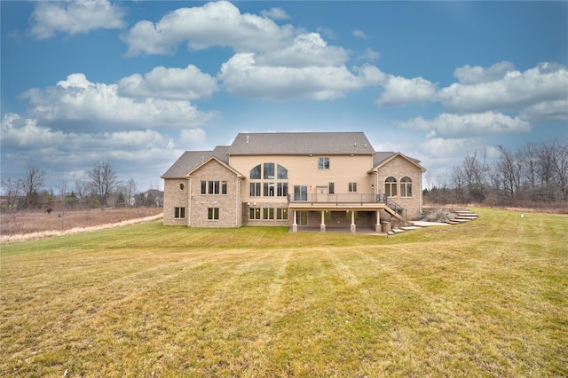 8498 Highgrove Ct, Grand Blanc, MI 48439 - back of house with a deck, a lawn, stairway, and brick siding