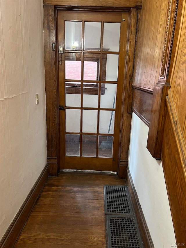 doorway to outside featuring dark wood-type flooring