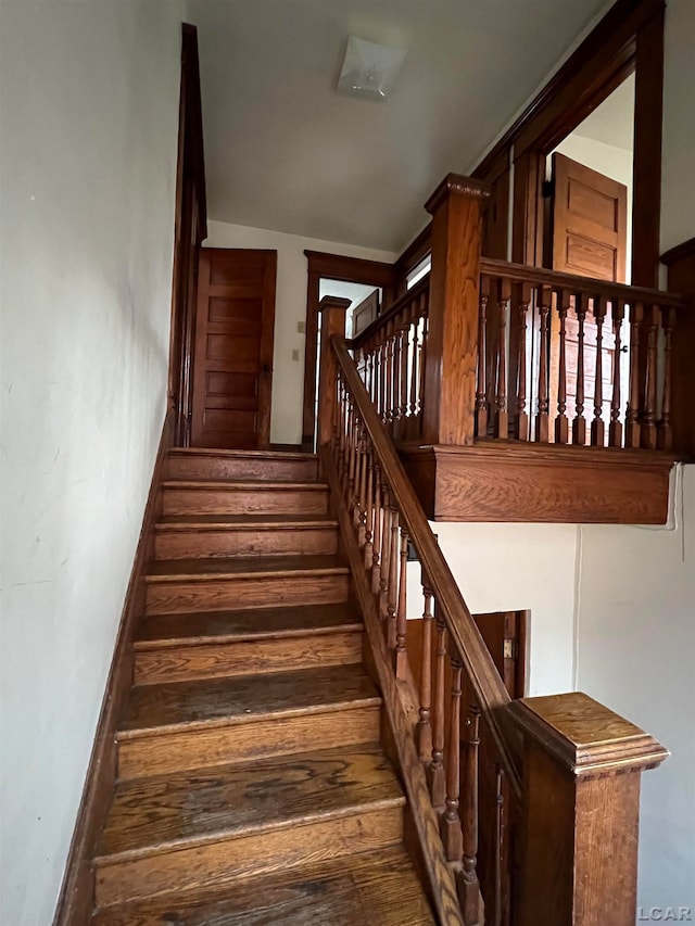 staircase with hardwood / wood-style floors