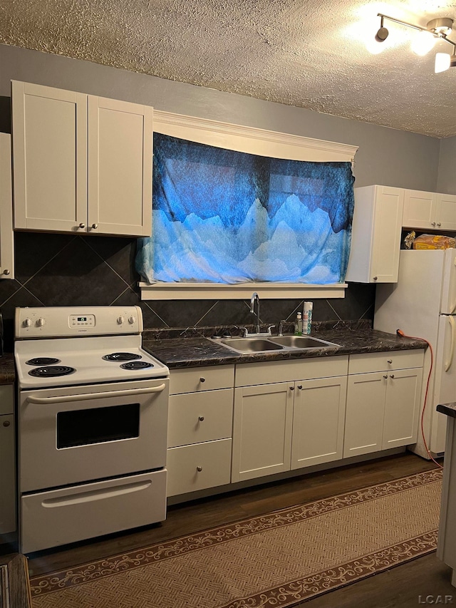 kitchen with decorative backsplash, white appliances, sink, white cabinets, and dark hardwood / wood-style floors