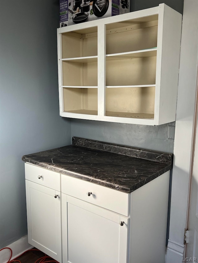 kitchen with white cabinets and dark stone counters