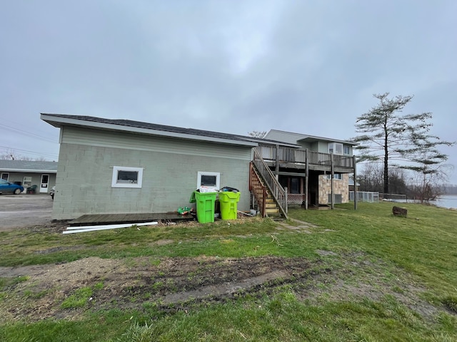 9470 Pontiac Lake Rd, White Lake, MI 48386 - back of house with stairway, a deck, a yard, and concrete block siding