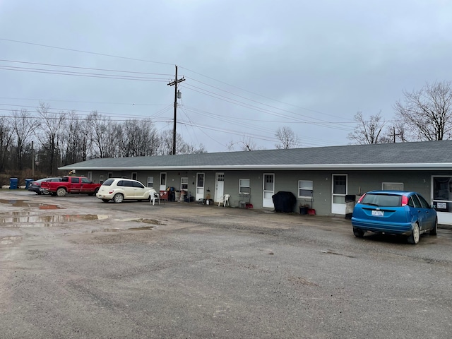 9470 Pontiac Lake Rd, White Lake, MI 48386 - view of building exterior with uncovered parking