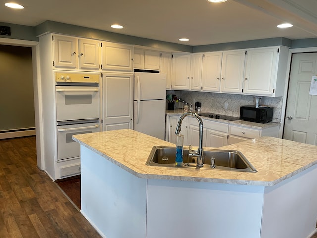 kitchen featuring dark wood-type flooring, sink, white cabinets, and black appliances