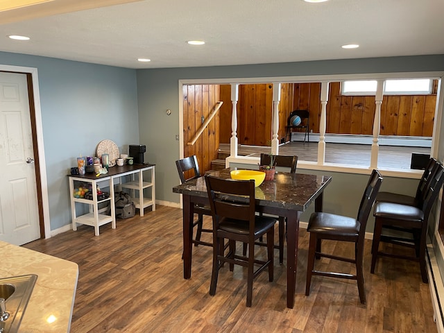 dining space featuring dark hardwood / wood-style flooring and a baseboard radiator