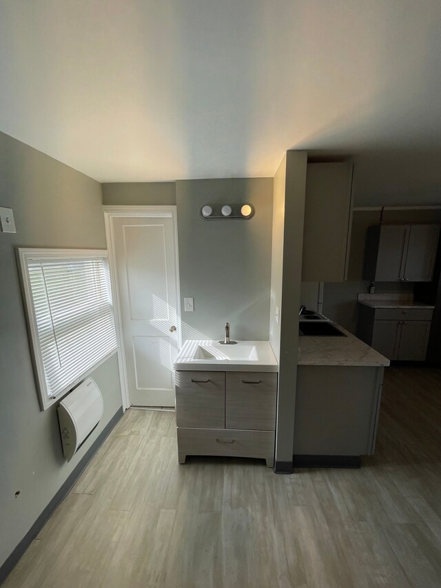 9470 Pontiac Lake Rd, White Lake, MI 48386 - bathroom with wood finished floors, baseboards, and a sink