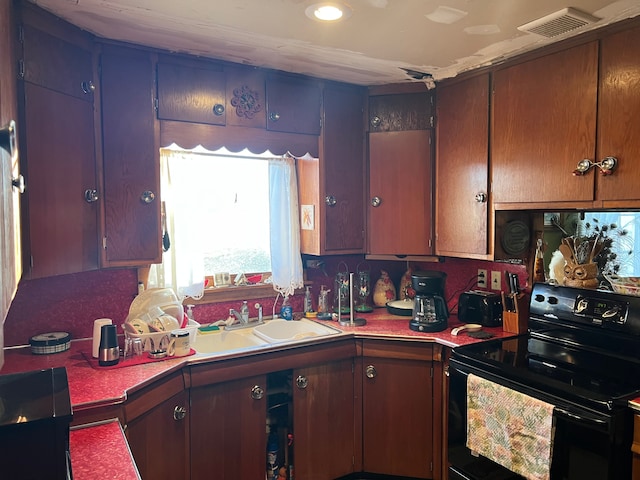 kitchen featuring sink and black range with electric cooktop