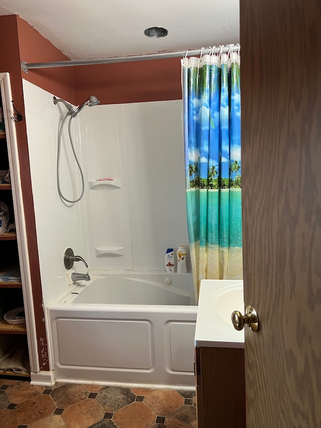 bathroom featuring shower / bath combo and vanity