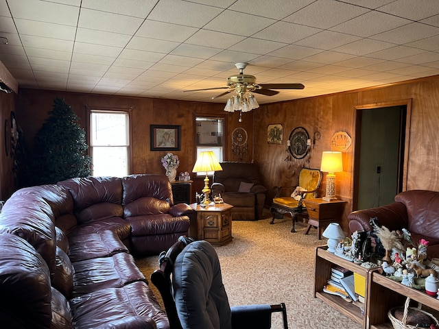 living room featuring wooden walls and ceiling fan