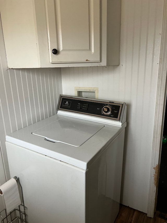 laundry room with dark hardwood / wood-style floors, cabinets, and washer / clothes dryer