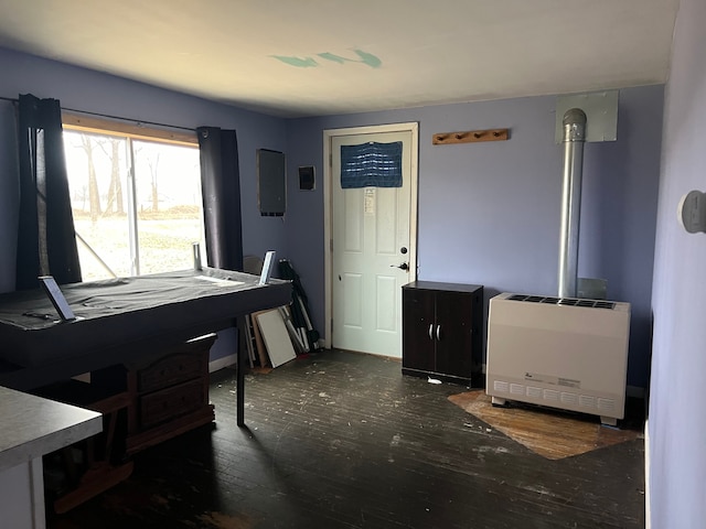 office space featuring heating unit and dark hardwood / wood-style flooring