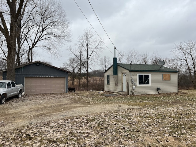 view of side of home with an outbuilding and a garage