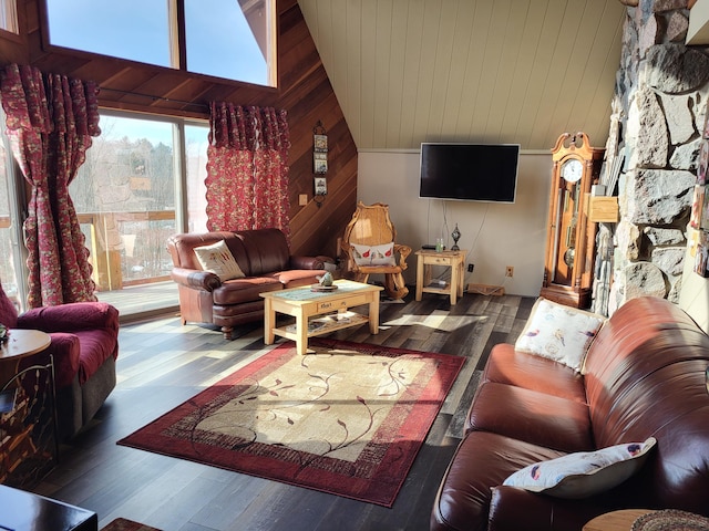 living room with dark wood-type flooring, high vaulted ceiling, and wooden walls