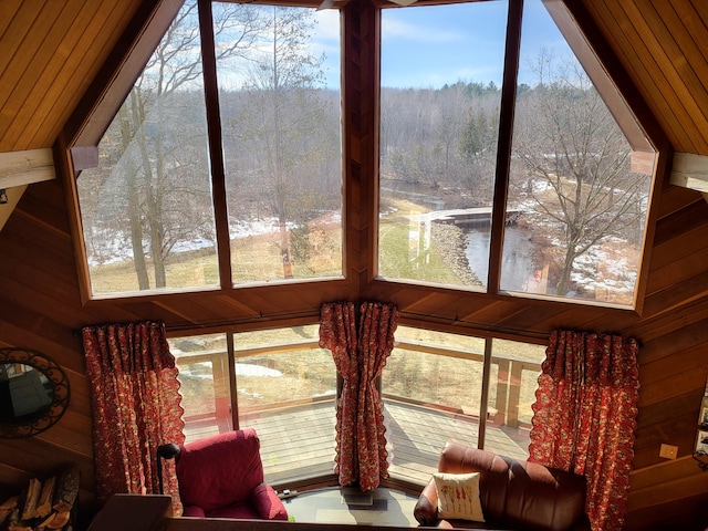 sunroom / solarium featuring wood ceiling, a water view, lofted ceiling, and a wealth of natural light