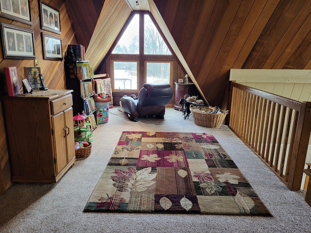 interior space with light colored carpet, vaulted ceiling, and wooden walls