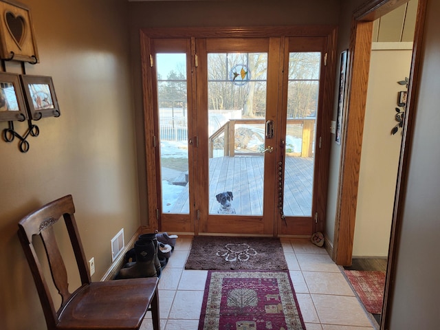 doorway to outside featuring french doors and light tile patterned flooring