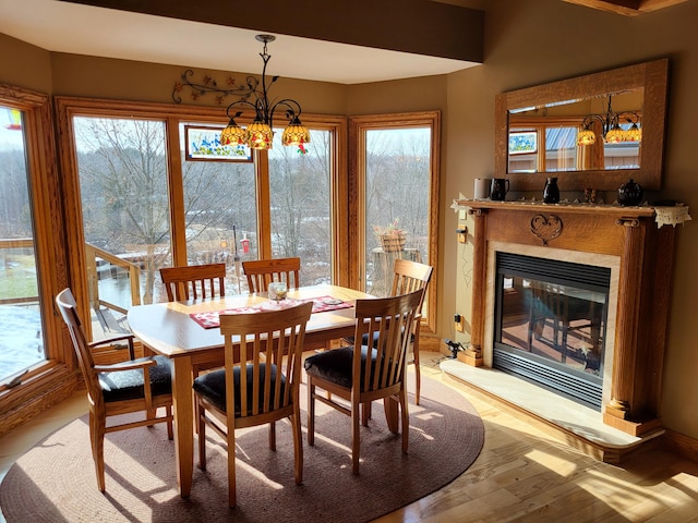 dining area with a notable chandelier and light hardwood / wood-style floors