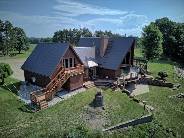 back of property featuring a yard and a wooden deck