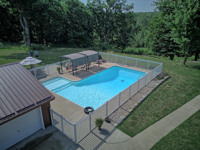 view of pool with a lawn and a patio