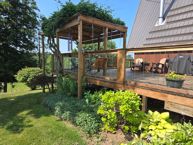 wooden terrace with area for grilling and a lawn