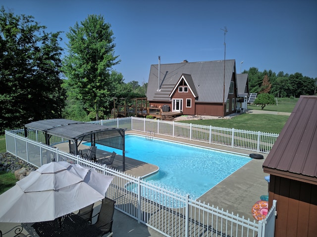 view of pool featuring a patio area and a yard