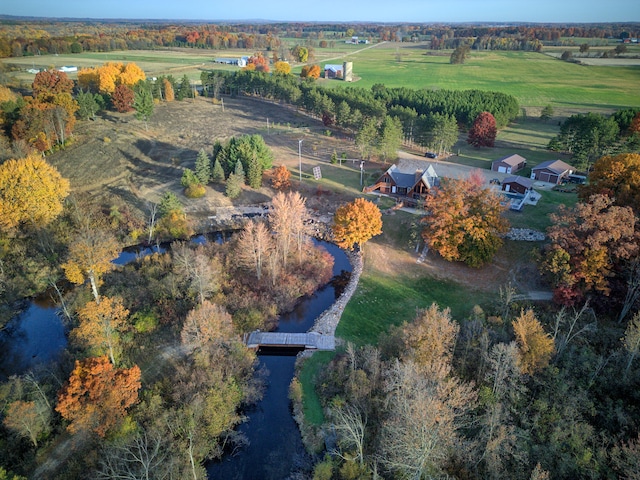 birds eye view of property featuring a water view and a rural view