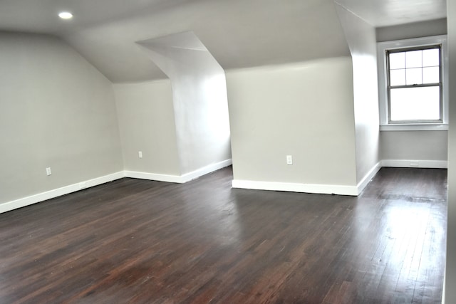 additional living space featuring dark hardwood / wood-style flooring and lofted ceiling